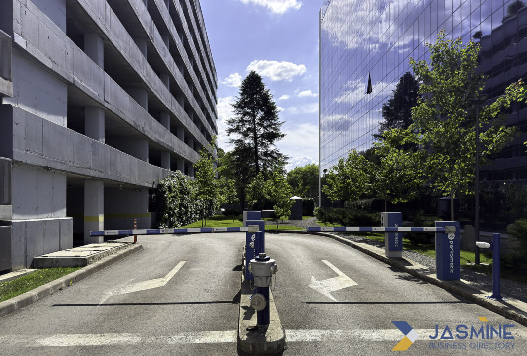 Professional office complex entrance illustrates modern legal infrastructure for law firm directory research Modern office complex entrance with glass buildings and security barriers, representing professional business infrastructure for legal directory searches.