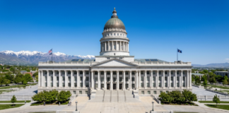 The Utah State Capitol building with its iconic dome and columned entrance under clear skies, symbolizing the state's legal and governmental authority structure.